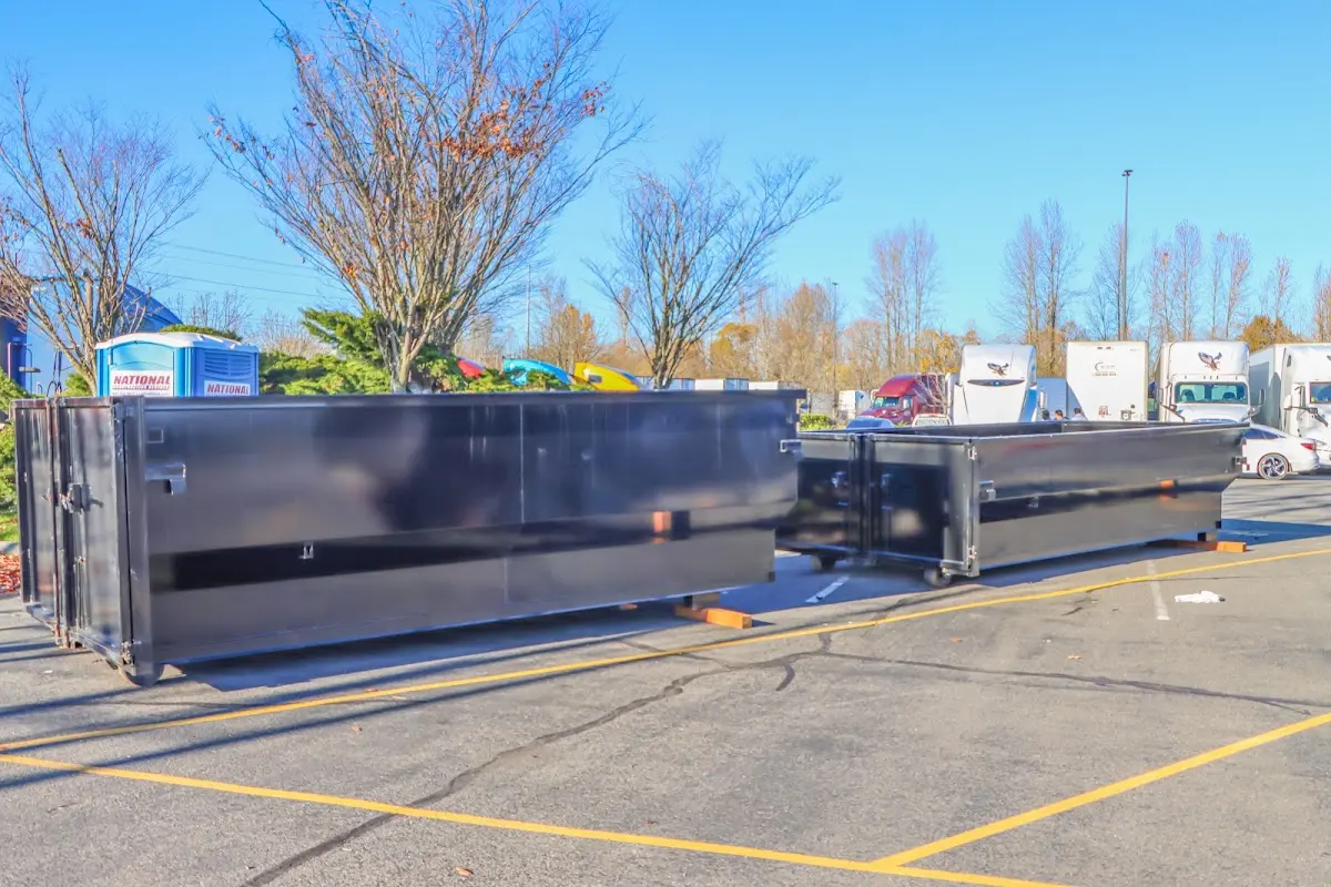 Professional dumpster rental service with roll-off container on residential driveway in Horseshoe Bay